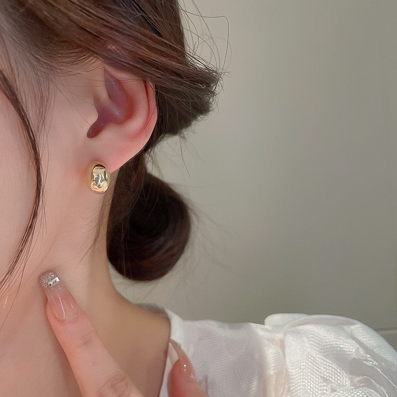 Gold and silver bean stud earrings